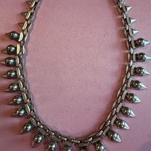 May include: A rustic wooden sign with the text "Welcome to our home" in white lettering. The sign features a distressed finish and a simple, inviting design, perfect for entryway decor.