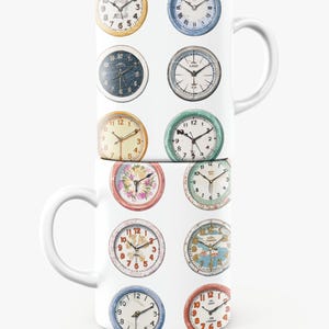 May include: Two white ceramic mugs stacked, each adorned with a repeating pattern of vintage clock faces. The clocks feature various colors and designs, including Roman numerals and floral accents. The mugs have white handles.