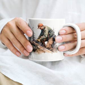 May include: White ceramic mug featuring a watercolour illustration of a person using a chainsaw to cut a log. The person is wearing a red hat, green jacket, and brown trousers.