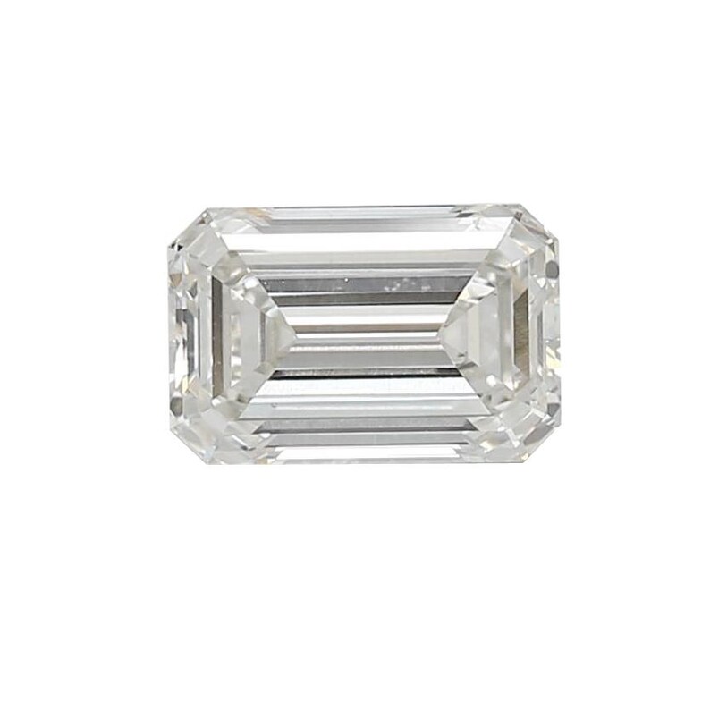 May include: An emerald-cut diamond, rectangular in shape, with step-cut facets. The colourless gemstone exhibits high clarity and brilliance, reflecting light across its surface. The diamond is set against a white background.