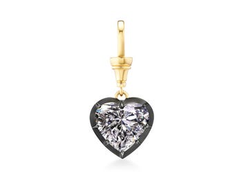 May include: A heart-shaped pendant with a large, sparkling diamond. The diamond is set in a dark metal frame and hangs from a gold-colored bail. The pendant is designed to be worn as a charm or a pendant.