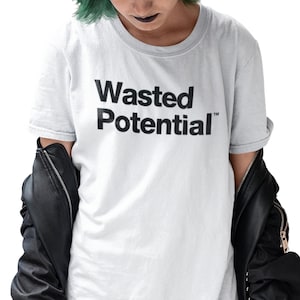 May include: A white t-shirt with black text that reads "Wasted Potential" with a trademark symbol.