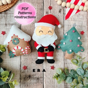 Pode incluir: Adornos de Natal de feltro, incluindo uma casa de gengibre, Papai Noel e uma árvore de Natal. Os adornos estão sobre um fundo de madeira com o texto "PDF Patterns +Instructions" e "ERA".