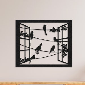 May include: Black metal wall art depicting a window with birds perched on a wire. The window is open and there are branches and leaves on either side.