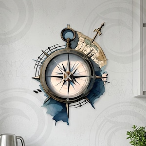May include: A metal wall art piece featuring a compass design. The compass is detailed with a dark metal finish, a white face, and a starburst pattern. It is set against a watercolor-style blue and tan background, creating a nautical theme.