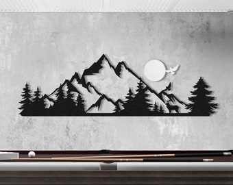 May include: Black metal mountain and forest wall art decor. The silhouette design features a mountain range, trees, a deer, a sun, and a flying bird. The artwork is displayed above a pool table with a burgundy felt surface.