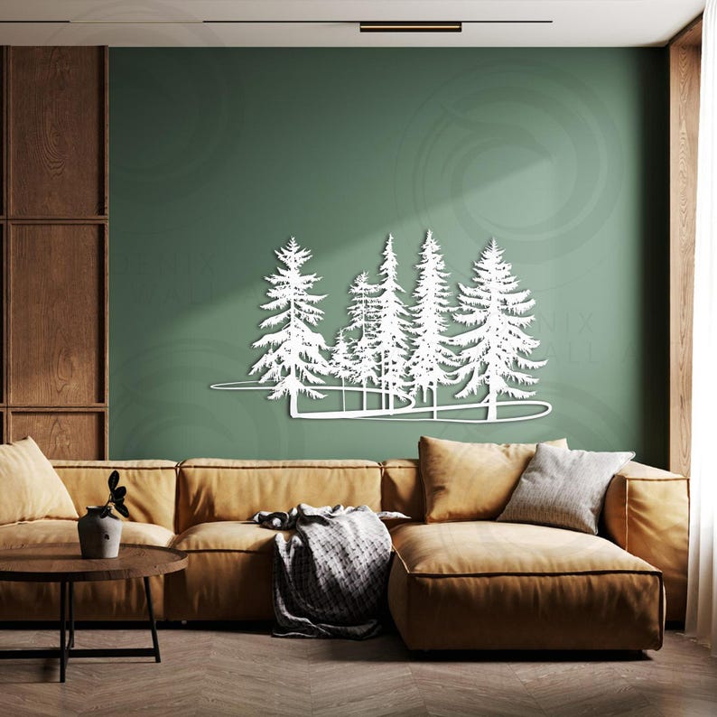 May include: A white metal wall art sculpture depicting a forest scene with multiple trees. The sculpture is mounted on a green wall above a brown couch with throw pillows.