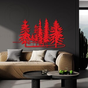 May include: Red metal wall art depicting a silhouette of a forest with multiple pine trees. The art is mounted on a dark gray wall above a brown couch.