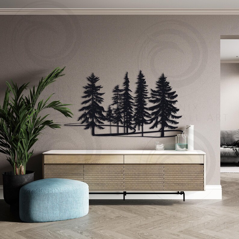 May include: Black metal wall art depicting a silhouette of a forest with pine trees. The art is mounted on a white wall above a light wood cabinet with a woven pattern.