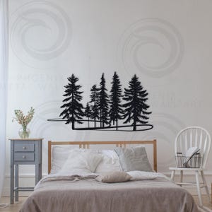 May include: Black metal wall art depicting a silhouette of a forest with trees of varying heights. The art is mounted on a white wall above a bed with gray bedding.