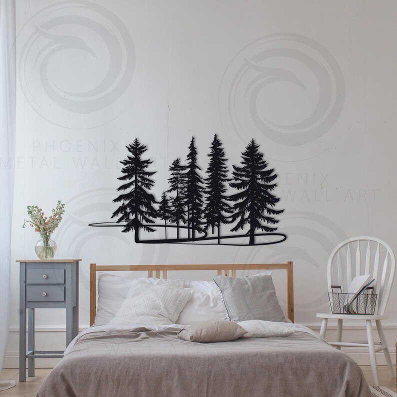 May include: Black metal wall art depicting a silhouette of a forest with trees of varying heights. The art is mounted on a white wall above a bed with gray bedding.