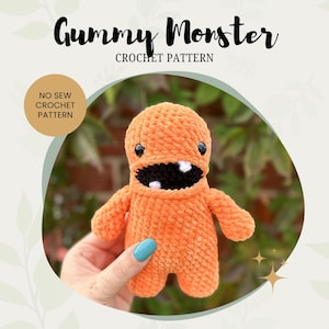 May include: An orange crocheted monster with a wide, toothy grin and small black eyes. The text "Gummy Monster Crochet Pattern" is displayed above the monster. A circular graphic reads "No Sew Crochet Pattern".