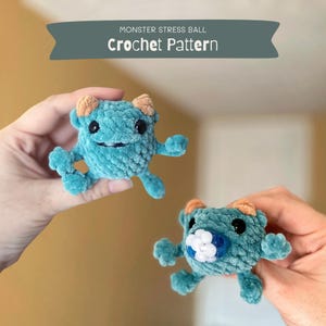 May include: Two crocheted teal monster stress balls with orange horns. One monster has a white bead for a mouth, the other has a black bead for a mouth.  Monster Stress Ball Crochet Pattern.