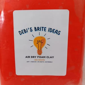 May include: A red package of air dry foam clay. The package has a white label with the text "DEBI'S BRITE IDEAS" and a lightbulb graphic. The label also says "AIR DRY FOAM CLAY 500 GRAMS SOFT - STRETCHY - DIY CRAFTS - KID FRIENDLY".