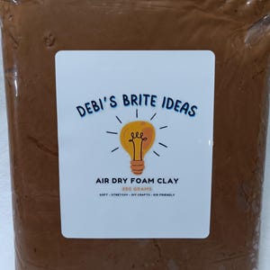 May include: A package of brown air dry foam clay. The label reads "DEBI'S BRITE IDEAS" with a lightbulb graphic. The label also states "AIR DRY FOAM CLAY 500 GRAMS SOFT - STRETCHY - DIY CRAFTS - KID FRIENDLY."