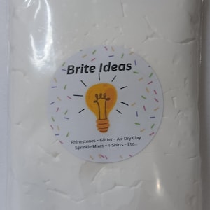 May include: A clear plastic bag filled with white air-dry clay. A circular sticker on the bag reads "Brite Ideas" with a lightbulb graphic and text listing craft supplies like rhinestones and glitter.