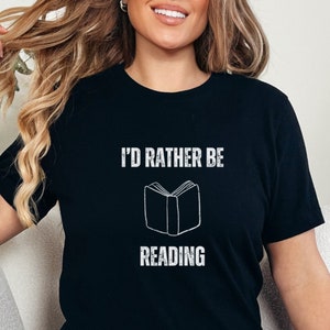 May include: A black t-shirt with the text "I'd rather be reading" and a stylized image of an open book.