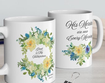 May include: Two white ceramic mugs with floral designs. One mug features the text "Great is Thy Faithfulness" and the other mug features the text "His Mercies are new Every Morning".