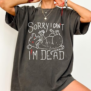 Text: "Sorry I Can't I'm Dead" Possum Sketch, Tongue Out with X Eyes Gray Shirt, White Text and Outline, Funny Meme Tee, Introverted, Anxiety Opossum, Unhinged Tees, Weird Sarcastic, Shirts that go Hard, Oversized Rave Tshirt Ironic Shirts Gift Ideas