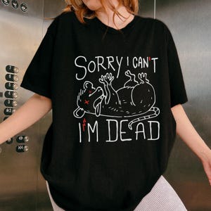Text: "Sorry I Can't I'm Dead" Possum Sketch, Tongue Out with X Eyes Black Shirt, White Text and Outline, Funny Meme Tee, ADHD, Anxiety Opossum, Unhinged Tees, Weird Sarcastic, Shirts that go Hard, Oversized Grunge Tshirt Ironic Shirts, Unhinged