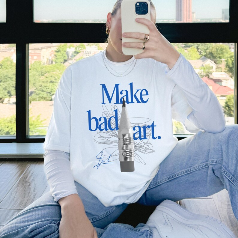 Comfort Colors 1717 Shirt
Color: White
Graphic: Bold blue text that reads ‘Make bad art' behind a pencil graphic, with scribble doodle lines in gray and a signature-style accent in bottom corner
Title: Make Bad Art Shirt, Artist Oversized Statement Tee, Streetwear Y2K Style, Vintage Aesthetic, Artsy Gift, Alt Clothing, Comfort Colors Unisex