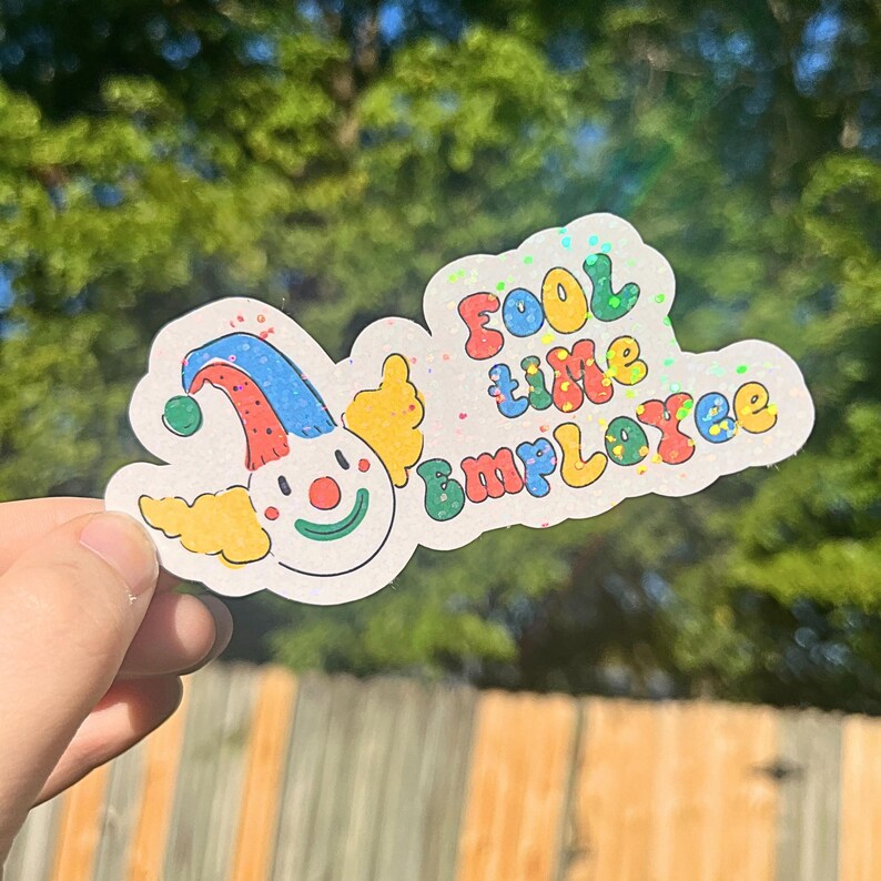 May include: A white sticker with a colorful cartoon clown and the text "Fool time Employee".