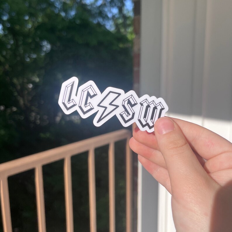 May include: A white sticker with a black outline of the letters LCSW with a lightning bolt between the C and S.
