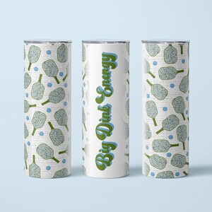 May include: Three white tumblers with a green and blue pickleball pattern. The center tumbler has the text "Big Dink Energy" in green and blue.