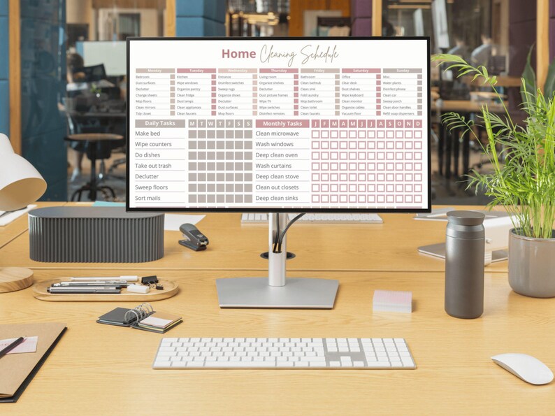 May include: A computer monitor displaying a printable home cleaning schedule with a checklist for daily and monthly tasks. The schedule includes tasks like making the bed, wiping counters, doing dishes, taking out the trash, decluttering, sweeping floors, sorting mail, cleaning the microwave, washing windows, deep cleaning the oven, washing curtains, deep cleaning the stove, cleaning out closets, and deep cleaning sinks.