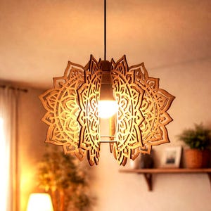 May include: A wooden pendant light fixture with an intricate, laser-cut mandala design. The light fixture is suspended from a black cord and features a warm, glowing bulb. The fixture is made of light-colored wood and is a decorative home decor item.