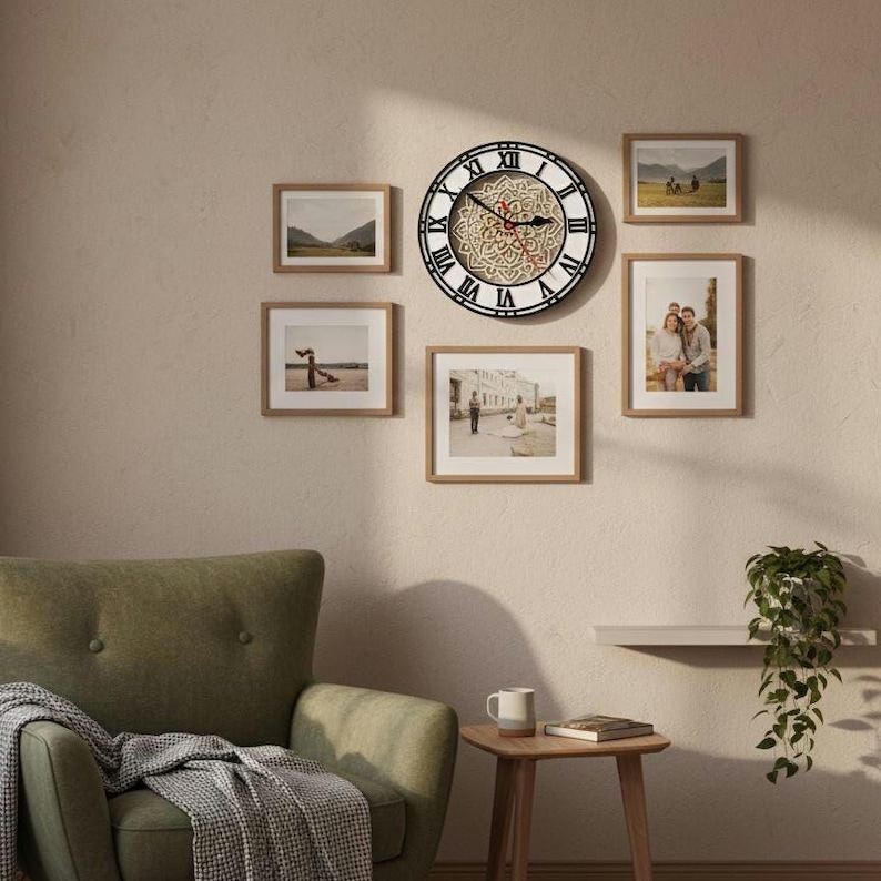 May include: A wall decor arrangement featuring a large round clock with Roman numerals and a decorative center, surrounded by framed photographs. The clock has a black frame and a white face with a detailed design. The frames are a light brown color.
