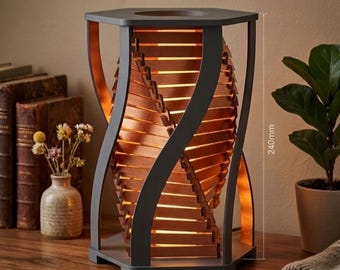 May include: A decorative wooden table lamp with a unique spiral design. The lamp features a dark gray frame with wooden slats and measures approximately 9.4 inches (240mm) in height. The lamp is illuminated from within, creating a warm glow.