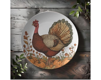 May include: A white ceramic dinner plate featuring a colourful illustration of a turkey surrounded by autumn foliage and pumpkins. The turkey has a red head and a brown and white body with a large, colourful tail.