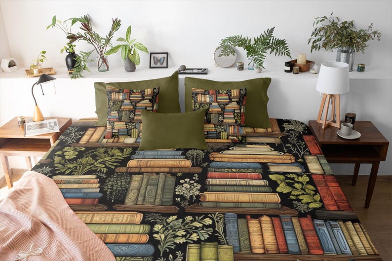 May include: A black and green bedding set with a pattern of stacked books and botanical illustrations. The bedding set includes two pillowcases and a duvet cover.