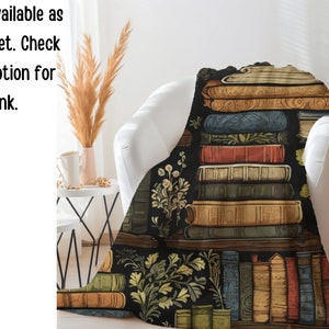 May include: A black and white throw blanket with a pattern of stacked books and floral accents. The books have detailed illustrations and are arranged in a bookshelf style.