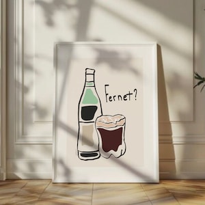 May include: A white framed print with a beige background featuring a black and green bottle and a glass of brown liquid. The text "Fernet?" is written in black above the glass.