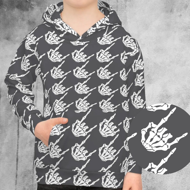 May include: A gray hooded sweatshirt with a white skeleton hand making a middle finger gesture repeated in a pattern.