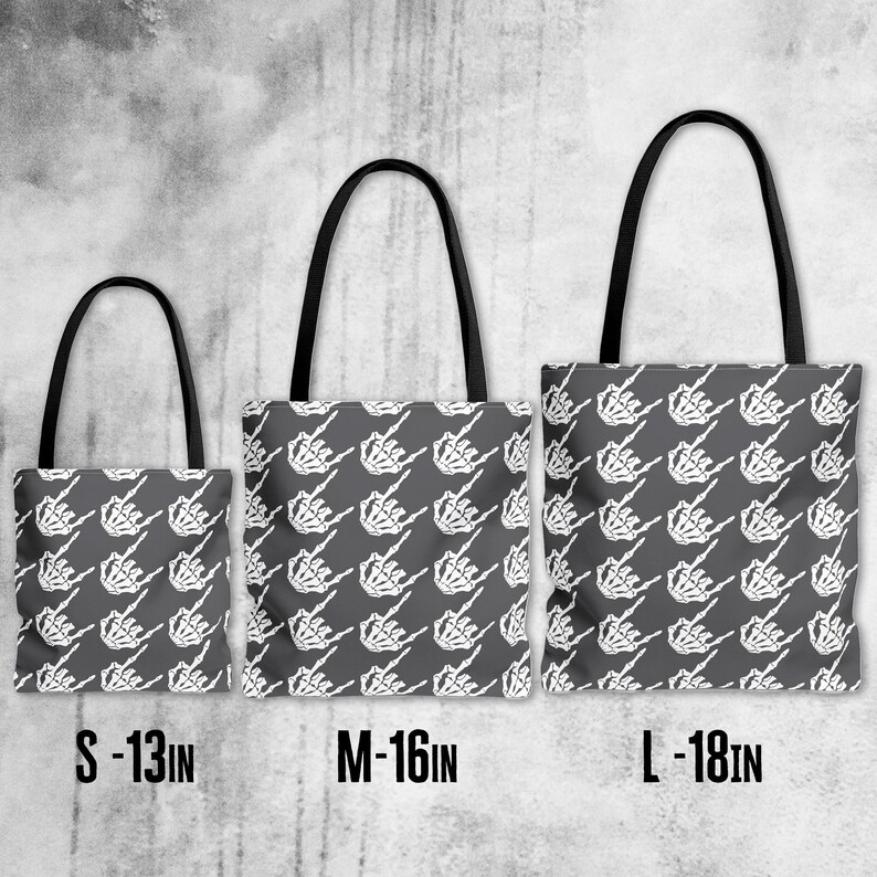 May include: Three tote bags with black handles and a repeating white skeleton hand design on a gray background. The bags are labeled S - 13IN, M - 16IN, and L - 18IN, indicating their sizes.