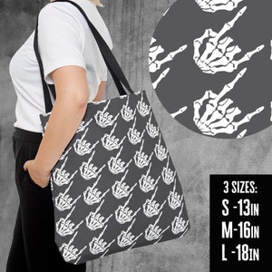 May include: A gray tote bag featuring a repeating pattern of white skeleton hand gestures. The bag has black straps and is shown in three sizes: S - 13 inches, M - 16 inches, and L - 18 inches.