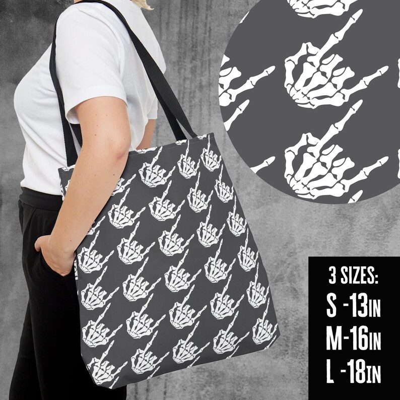 May include: A gray tote bag featuring a repeating pattern of white skeleton hand gestures. The bag has black straps and is shown in three sizes: S - 13 inches, M - 16 inches, and L - 18 inches.