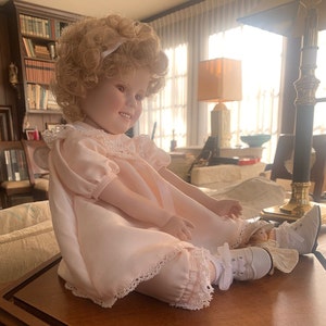 Shirley Temple Doll under Mirrored Glass Case with Solid Wood Base.
