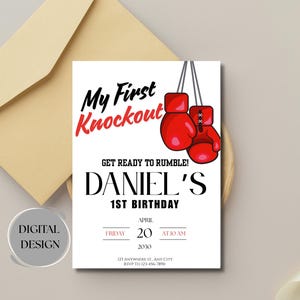 May include: A white invitation card with the text "My First Knockout" in black and red, featuring red boxing gloves. The card is for Daniel's 1st birthday, with the date and time displayed. An envelope is in the background.