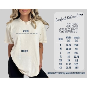 May include: Cream-coloured t-shirt with a size chart. The chart lists sizes S to 4XL, with width and length measurements in inches. The text "Comfort Colors C1717" is at the top. A model wearing a medium size is shown.