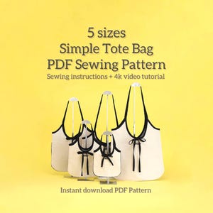 May include: Four cream-coloured tote bags of different sizes, each with black trim and handles, are displayed against a yellow backdrop. The bags are on silver stands. Text reads "5 sizes Simple Tote Bag PDF Sewing Pattern" and "Instant download PDF Pattern."