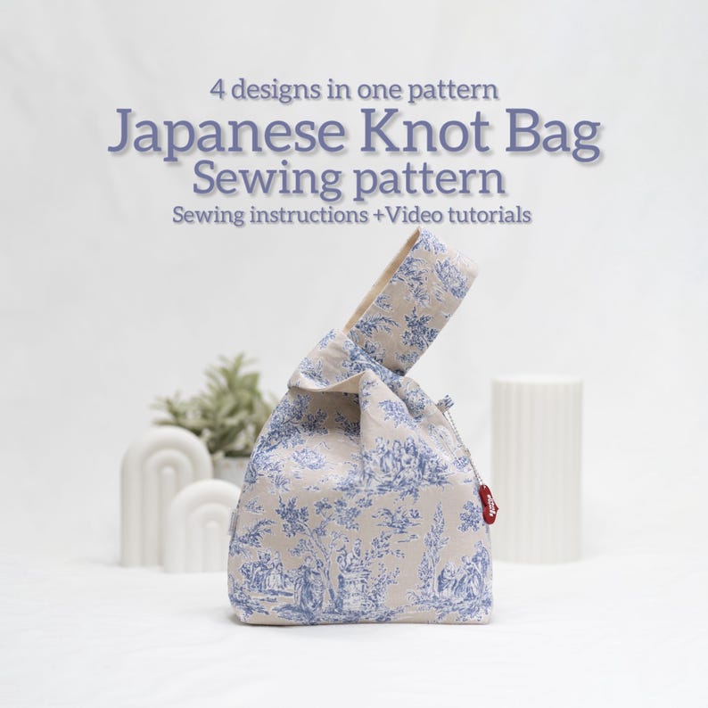 May include: A beige and blue Japanese knot bag sewing pattern with a floral print. The pattern includes sewing instructions and video tutorials. 4 designs in one pattern.