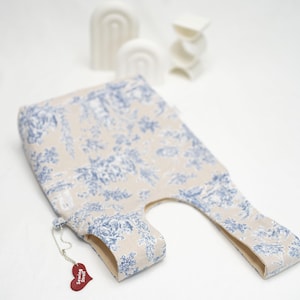 May include: A beige tote bag with a blue floral pattern. The bag has a small red heart-shaped tag with the text "Sewing Stuff" on it.