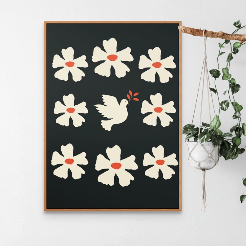 May include: A framed print with a black background featuring a white dove carrying an olive branch and surrounded by white flowers with red centers.