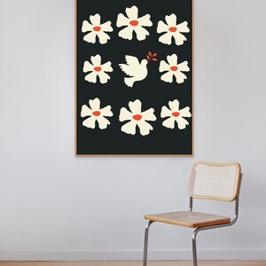 May include: A framed print with a black background and white flowers with red centers. A white dove with an olive branch in its beak flies in the center of the print.