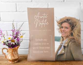 May include: A beige throw pillow with a photo of a woman and the text "Auntie Natalie" with the dates "October 06, 1955 - May 07, 2023". The text "Include any custom text or quote from your loved one here." is also on the pillow.