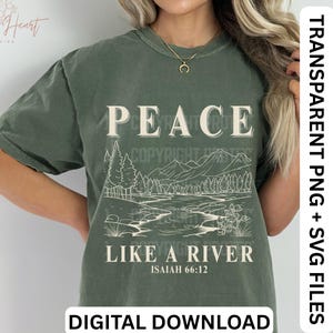 May include: Olive green t-shirt with the word "PEACE" in a bold, serif font above a landscape illustration of a river and mountains. The text "LIKE A RIVER" and "ISAIAH 66:12" are below the illustration. The words "DIGITAL DOWNLOAD" are at the bottom.